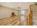 Spacious living room with wood flooring, a brick fireplace, and staircase at 2436 Green Hollow Ct, Conyers, GA 30012