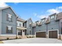 Stylish home showing garage doors and covered entry, with vertical siding and stone accents at 2517 Canopy Ct, Marietta, GA 30066