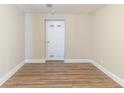 A finished basement room featuring wood floors, a crisp white door, and neutral wall paint at 3716 Loren Dr, Decatur, GA 30032