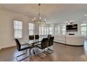 Open concept living and dining area with gleaming hardwood floors and bright, natural light at 3856 Allegretto Cir, Atlanta, GA 30339