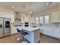 Modern eat-in kitchen with stainless steel appliances, center island and stylish pendant lighting at 3856 Allegretto Cir, Atlanta, GA 30339