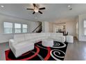 Cozy living room featuring hardwood floors, modern ceiling fan, and spiral patterned area rug at 3856 Allegretto Cir, Atlanta, GA 30339