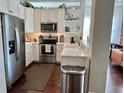 Well-lit kitchen with stainless steel appliances, white cabinets, and quartz countertops at 800 Peachtree Ne St # 8415, Atlanta, GA 30308