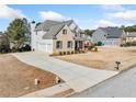 An exterior view of the home showcasing the driveway and three-car garage at 1151 Nash Lee Sw Dr, Lilburn, GA 30047