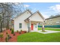 Beautiful exterior view of a home with a bright red door and lush green lawn at 395 W Lake Nw Ave, Atlanta, GA 30318