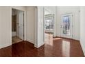 Bright entryway with gleaming hardwood floors, white trim, and a decorative glass front door at 5955 Princeton Run Trl, Tucker, GA 30084