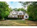 Charming home with a manicured front yard and mature trees offering great curb appeal at 160 Edgewater Trl, Fayetteville, GA 30215