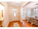 Inviting foyer with hardwood floors leading to a dining area with a rustic wooden table at 160 Edgewater Trl, Fayetteville, GA 30215