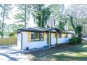 Single-story brick home with decorative shutters, refreshed landscaping, and a paved driveway at 455 Dollar Mill Sw Rd, Atlanta, GA 30331