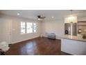 Living space with hardwood floors, bright light, and a granite-topped kitchen island at 455 Dollar Mill Sw Rd, Atlanta, GA 30331