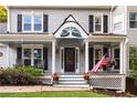 Inviting front porch with rocking chairs, an American flag, and decorative details at 1421 Eryn Cir, Suwanee, GA 30024