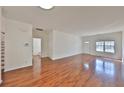 Bright living room features hardwood floors, a large window, and fresh paint throughout at 2359 Suwanee Pointe Dr, Lawrenceville, GA 30043