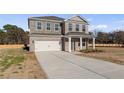 Attractive two-story brick house with an attached garage, featuring a long driveway and well-maintained front lawn at 120 Dalston Cv, Stockbridge, GA 30281