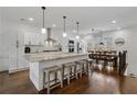 Bright and airy kitchen featuring white cabinetry, stainless steel appliances, and a large center island with bar seating at 3908 Charleston Market St, Suwanee, GA 30024