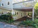 Back of house featuring a grey deck and backyard landscaping at 724 Se Cowan Se Rd, Conyers, GA 30094