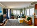 A shot of the living room, showing the sofa, windows, desk, and rug at 795 Hammond Dr # 1812, Atlanta, GA 30328