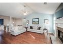 Inviting living room with hardwood floors, a fireplace, access to the dining room, and neutral-toned furniture at 1971 Commonwealth Way, Grayson, GA 30017