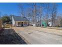 Exterior shot of a house featuring a cozy yard and driveway at 2550 Belaire Dr, Cumming, GA 30041