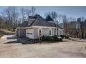 Angle view of the home displaying the attached garage, long driveway, and turret at 4610 Riversound Drive, Snellville, GA 30039