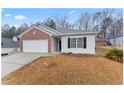 Charming single-story home with a brick and white siding, complemented by an attached two-car garage at 10231 Deep Creek Pl, Union City, GA 30291