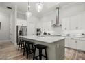 Modern kitchen featuring a large island, stainless steel appliances, and stylish pendant lighting at 118 Village Green Ave, Woodstock, GA 30189