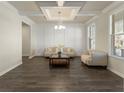 Bright living room with coffered ceiling, hardwood floors, and large windows providing natural light at 3218 Hidden Valley Cir, Lawrenceville, GA 30044