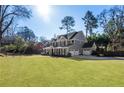 Sprawling front lawn showcases this gray two-story home with a convenient two-car garage at 2190 Rugby Ave, Atlanta, GA 30337