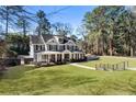 Beautiful two-story home with manicured lawn, mature trees, and a welcoming front porch at 2190 Rugby Ave, Atlanta, GA 30337