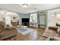 Bright living room with wood floors, and a large window providing natural light at 3653 Memorial Nw Pkwy, Kennesaw, GA 30152