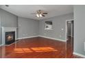 Bright living room features a fireplace, ceiling fan, and lovely wood floors at 5362 Hickory Nw Knl, Norcross, GA 30071