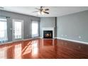 Sun-filled living room with fireplace, and hardwood floors; door leads to patio or balcony at 5362 Hickory Nw Knl, Norcross, GA 30071