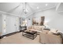 Bright living room featuring hardwood floors, a vaulted ceiling, and neutral décor at 2413 Drew Valley Rd, Brookhaven, GA 30319