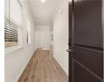 Inviting entryway with wood-look floors, white walls, and natural light streaming through the window at 1084 Georgian Point Dr, Lawrenceville, GA 30045