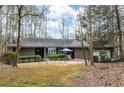 Single-story home with an inviting outdoor seating area surrounded by natural landscape at 2796 County Line Nw Rd, Acworth, GA 30101