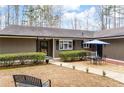 Charming home featuring manicured shrubs leading to the inviting front entrance with blue shutters at 2796 County Line Nw Rd, Acworth, GA 30101