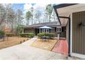 View of front entrance featuring outdoor table seating with umbrella and a well-manicured lawn at 2796 County Line Nw Rd, Acworth, GA 30101