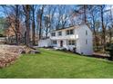 Angle view of a charming white two-story home with green lawn and an attached garage at 2818 Thornbriar Rd, Atlanta, GA 30340