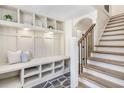 Foyer featuring built-in storage, slate tile, and hardwood stairs at 2818 Thornbriar Rd, Atlanta, GA 30340
