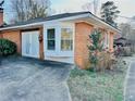 Brick garage featuring a bay window and double doors at 3112 Laura Ln, Lithia Springs, GA 30122