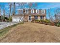 Traditional-style home with brick facade, attached garage, and mature landscaping in a suburban setting at 3461 Valley View Dr, Marietta, GA 30068