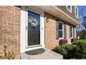 Close-up of brick home's entryway, featuring a white-trimmed door, black shutters, and flower boxes at 3461 Valley View Dr, Marietta, GA 30068