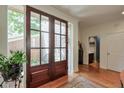 Bright foyer featuring hardwood floors and elegant glass double doors at 3994 Columns Dr, Marietta, GA 30067