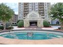 Up close view of the Park Towers entrance featuring a fountain and lush landscaping in a circular driveway at 795 Hammond Dr # 709, Atlanta, GA 30328