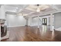 Bright living room showcasing coffered ceilings, a brick fireplace, and hardwood floors at 8900 River Trace Dr, Johns Creek, GA 30097