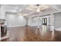 Living room with fireplace, hardwood floors, and coffered ceilings at 8900 River Trace Dr, Johns Creek, GA 30097