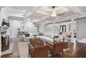 Spacious living room with coffered ceilings, brick fireplace, and comfortable seating arrangement at 8900 River Trace Dr, Johns Creek, GA 30097