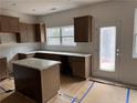 Bright kitchen featuring a center island, granite countertops and shaker style cabinets at 124 Bloomfield Cir, Canton, GA 30114