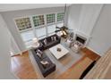 Aerial view of living room, with a fireplace, large windows and stylish furniture at 420 Glenridge Close Ct, Atlanta, GA 30328