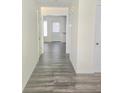 Bright hallway with wood-style tile flooring leading to various rooms at 2969 Wynhaven Oaks Way, Lawrenceville, GA 30042