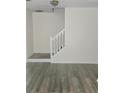 Open living area with wood-style tile flooring and a staircase at 2969 Wynhaven Oaks Way, Lawrenceville, GA 30042